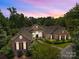 Stunning brick home with manicured landscaping and a beautiful sunset backdrop at 1629 Southpoint Ln, New London, NC 28127
