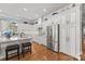 Bright kitchen boasts custom white cabinets, stainless steel appliances, and a granite-topped island at 1629 Southpoint Ln, New London, NC 28127