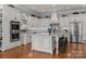 Spacious kitchen features custom white cabinets, stainless steel appliances, and granite countertops at 1629 Southpoint Ln, New London, NC 28127