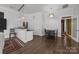 A modern kitchen featuring dark wood floors, a breakfast bar, and neutral colors at 1629 Southpoint Ln, New London, NC 28127