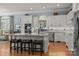 A well-lit kitchen features custom cabinets, an island with granite countertops, and stainless steel appliances at 1629 Southpoint Ln, New London, NC 28127