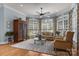 Bright living room with large windows, plush seating, and decorative rug at 1629 Southpoint Ln, New London, NC 28127