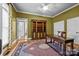 A spacious office features custom built-in shelving and a large desk, perfect for working from home at 1629 Southpoint Ln, New London, NC 28127