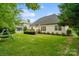 Large backyard offers ample green space, featuring a wooden deck, perfect for enjoying the outdoors at 1653 Shetland Ln, Rock Hill, SC 29730