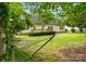 Expansive backyard featuring a hammock, a well-manicured lawn and mature trees at 1653 Shetland Ln, Rock Hill, SC 29730