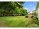 Spacious backyard with mature trees provides shade and privacy, enhanced with a wooden deck for relaxation at 1653 Shetland Ln, Rock Hill, SC 29730