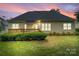 The home features a backyard with a wooden deck and manicured lawn, perfect for outdoor entertaining at 1653 Shetland Ln, Rock Hill, SC 29730
