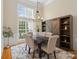 Bright dining room with a large window, stylish chandelier, and modern rustic accents at 1653 Shetland Ln, Rock Hill, SC 29730