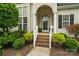 Inviting front entrance with brick steps, manicured landscaping, and a charming arched doorway at 1653 Shetland Ln, Rock Hill, SC 29730