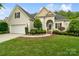 Charming home with a well-manicured lawn, two-car garage, and inviting entrance on a sunny day at 1653 Shetland Ln, Rock Hill, SC 29730