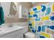 Bright bathroom featuring a white vanity, toilet, and a shower with a playful whale-themed curtain at 179 Browning Dr, Taylorsville, NC 28681