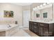 Luxurious bathroom featuring a soaking tub, tile surround, and dual vanity at 179 Browning Dr, Taylorsville, NC 28681