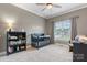 Cozy Bedroom featuring a crib, bookshelf, and a comfortable rocking chair by the window at 179 Browning Dr, Taylorsville, NC 28681