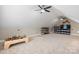 Large bonus room with a sloped ceiling, carpeted floor, two ceiling fans, and custom shelving at 179 Browning Dr, Taylorsville, NC 28681