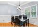 Bright dining room boasts a modern chandelier, large window, and classic wainscoting at 179 Browning Dr, Taylorsville, NC 28681