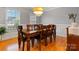Elegant dining room with a polished wood table, chandelier lighting, and classic wainscoting providing a perfect spot at 179 Browning Dr, Taylorsville, NC 28681