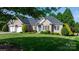 Charming brick home with manicured lawn, lush landscaping, and a welcoming blue front door at 179 Browning Dr, Taylorsville, NC 28681