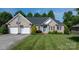 Charming brick home with a well-kept lawn, mature trees, and a driveway leading to a two-car garage at 179 Browning Dr, Taylorsville, NC 28681