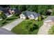 Charming brick home with a well-manicured lawn, lush landscaping, and a long driveway leading to the garage at 179 Browning Dr, Taylorsville, NC 28681