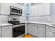 Stylish kitchen with stainless steel appliances, white cabinets, under-cabinet lighting, and ample counter space at 179 Browning Dr, Taylorsville, NC 28681