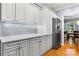 Modern kitchen with stainless steel refrigerator, white cabinets, granite countertops, and hardwood floors at 179 Browning Dr, Taylorsville, NC 28681