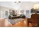 Bright living room with a vaulted ceiling, fireplace, and large windows offering natural light and comfortable seating at 179 Browning Dr, Taylorsville, NC 28681