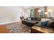 Spacious living room featuring a comfortable sectional sofa, hardwood floors, and views into the dining area at 179 Browning Dr, Taylorsville, NC 28681