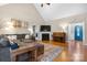 Inviting living room with a fireplace, vaulted ceilings, piano, and plush sectional sofa creating a cozy atmosphere at 179 Browning Dr, Taylorsville, NC 28681