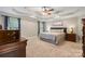 Spacious main bedroom featuring a tray ceiling, soft carpet, and a large window at 179 Browning Dr, Taylorsville, NC 28681