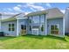 Beautiful backyard with large windows, a covered patio, and well-maintained green lawn at 18019 Wilbanks Dr, Charlotte, NC 28278