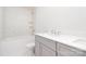 Stylish bathroom with a marble tiled wall, gray vanity, and shower-tub combination at 18019 Wilbanks Dr, Charlotte, NC 28278