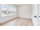 Bright bedroom featuring light wood floors, a neutral color palette, and three large windows allowing ample natural light at 18019 Wilbanks Dr, Charlotte, NC 28278