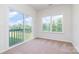 Bedroom featuring neutral carpet, a sliding glass door to the balcony, and a window overlooking the yard at 18019 Wilbanks Dr, Charlotte, NC 28278