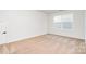 Cozy bedroom with neutral carpet, a double window, and a painted white door at 18019 Wilbanks Dr, Charlotte, NC 28278