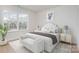 Bright bedroom offers a luxurious bed, bench, stylish decor and plenty of natural light at 18019 Wilbanks Dr, Charlotte, NC 28278