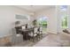 Bright dining room with an elegant chandelier and sliding glass doors offers a welcoming atmosphere at 18019 Wilbanks Dr, Charlotte, NC 28278