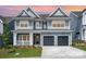 Charming two-story home featuring a welcoming front porch and a convenient two-car garage at 18019 Wilbanks Dr, Charlotte, NC 28278