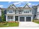 Charming two-story home with a covered porch, two-car garage, and well-manicured lawn at 18019 Wilbanks Dr, Charlotte, NC 28278