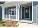Inviting front porch with white columns and railings, leading to the home's entrance at 18019 Wilbanks Dr, Charlotte, NC 28278