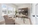 Inviting home office with large windows, comfortable seating, stylish desk, and decorative shelving at 18019 Wilbanks Dr, Charlotte, NC 28278
