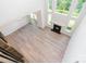 High angle view of an open-concept living room with fireplace, light wood floors, large windows, and ample natural light at 18019 Wilbanks Dr, Charlotte, NC 28278