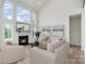 Cozy living room with a fireplace, large windows, neutral-toned furniture, and tasteful decor enhances the ambiance at 18019 Wilbanks Dr, Charlotte, NC 28278