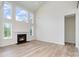 Spacious living room boasting a fireplace, high ceilings, and ample natural light from large windows at 18019 Wilbanks Dr, Charlotte, NC 28278