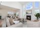 Bright living room with fireplace, large windows, and an adjacent dining area provides a cozy and inviting space at 18019 Wilbanks Dr, Charlotte, NC 28278