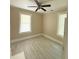 Bright bedroom featuring neutral paint, ceiling fan and light gray wood-look flooring at 2017 Ashley Rd, Charlotte, NC 28208