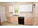 Updated kitchen with two-tone cabinets, stainless steel sink, and modern countertops at 2017 Ashley Rd, Charlotte, NC 28208