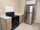 Bright kitchen featuring stainless steel fridge, electric range, and light wood cabinets at 2017 Ashley Rd, Charlotte, NC 28208
