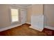 Inviting living area with hardwood floors and a painted brick fireplace, with natural light at 2017 Ashley Rd, Charlotte, NC 28208