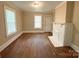 Comfortable living area with hardwood floors, a painted fireplace, and a window for ample light at 2017 Ashley Rd, Charlotte, NC 28208