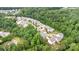 Aerial view of a residential neighborhood surrounded by lush, mature trees and greenery at 2037 Christopher Wood Ct, Fort Mill, SC 29707